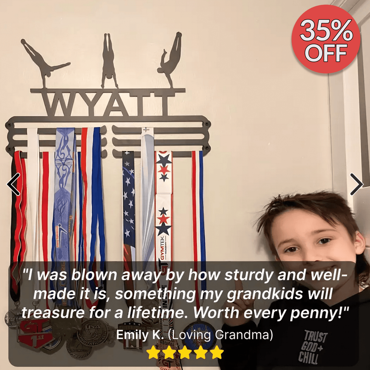 Customer photo of a personalized medal hanger mounted on a bedroom wall and filled with medals, with a five-star grandparent review