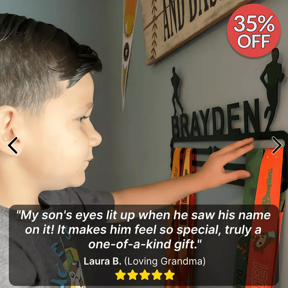 Customer photo of a boy reaching up to touch his name on his personalized medal hanger, with a five-star review